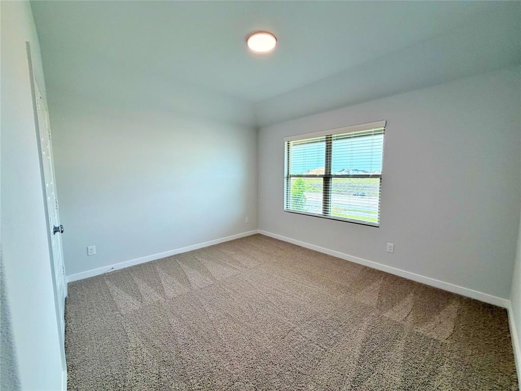 2203 Heatwave Lane Princeton, TX 75407 - Photo 14 of 32 an empty room with windows and closet