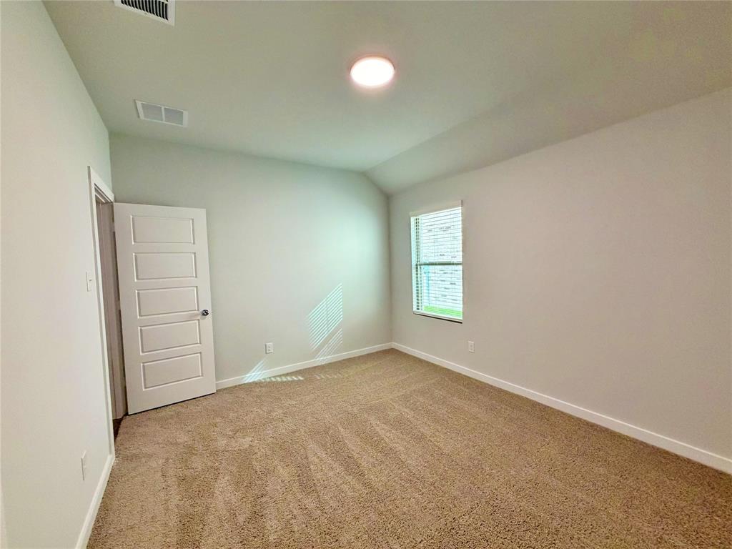 2203 Heatwave Lane Princeton, TX 75407 - Photo 15 of 32 an empty room with windows and closet