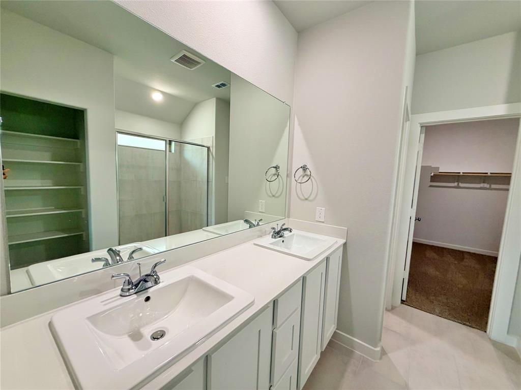 2203 Heatwave Lane Princeton, TX 75407 - Photo 20 of 32 a bathroom with a sink and a mirror