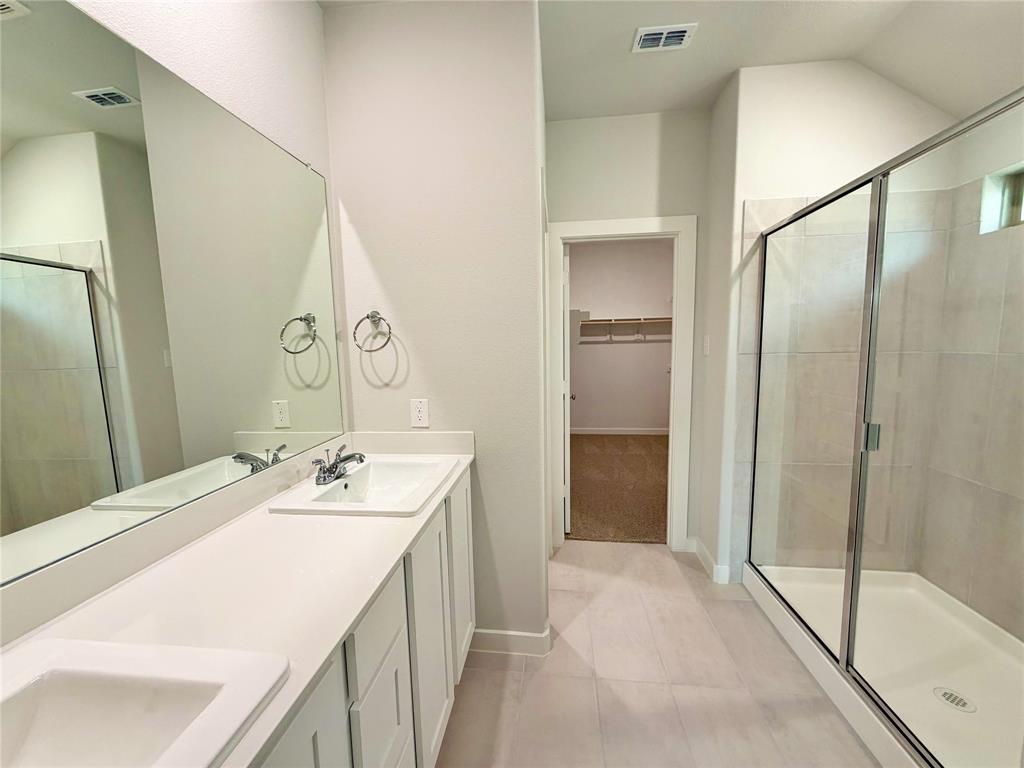 2203 Heatwave Lane Princeton, TX 75407 - Photo 21 of 32 a bathroom with a sink and a mirror