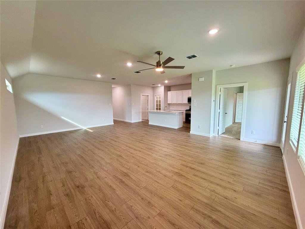 2203 Heatwave Lane Princeton, TX 75407 - Photo 4 of 32 a view of a kitchen with a dishwasher and wooden floor