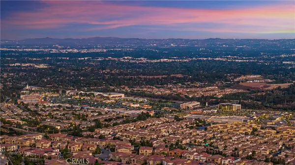 an aerial view of residential houses with city view