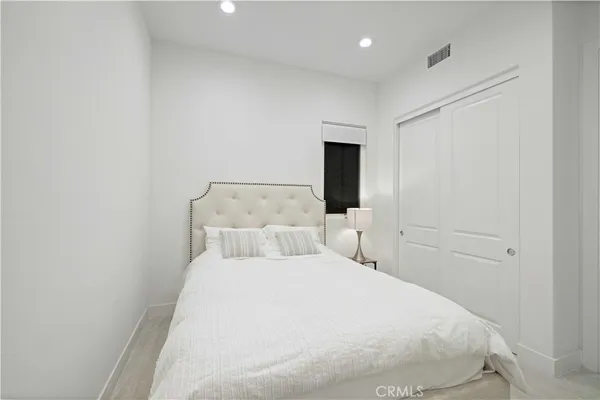 a large white bed in a white room