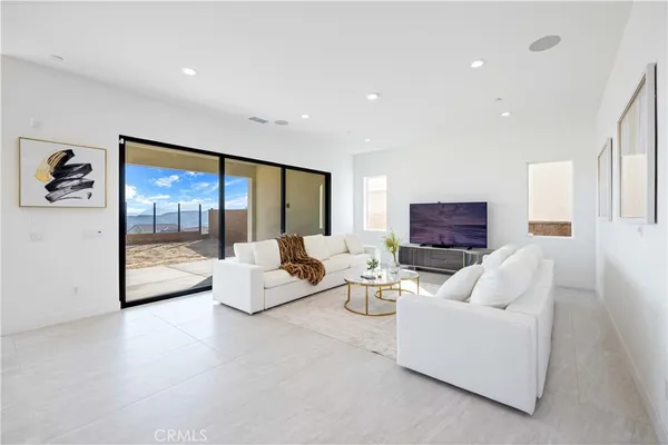 a living room with fireplace furniture and a large window