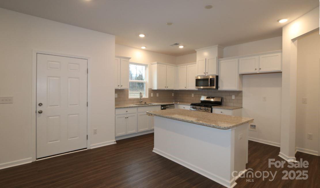 3540 Nimbell Road Monroe, NC 28110 - Photo 2 of 9 a kitchen with a sink window and cabinets