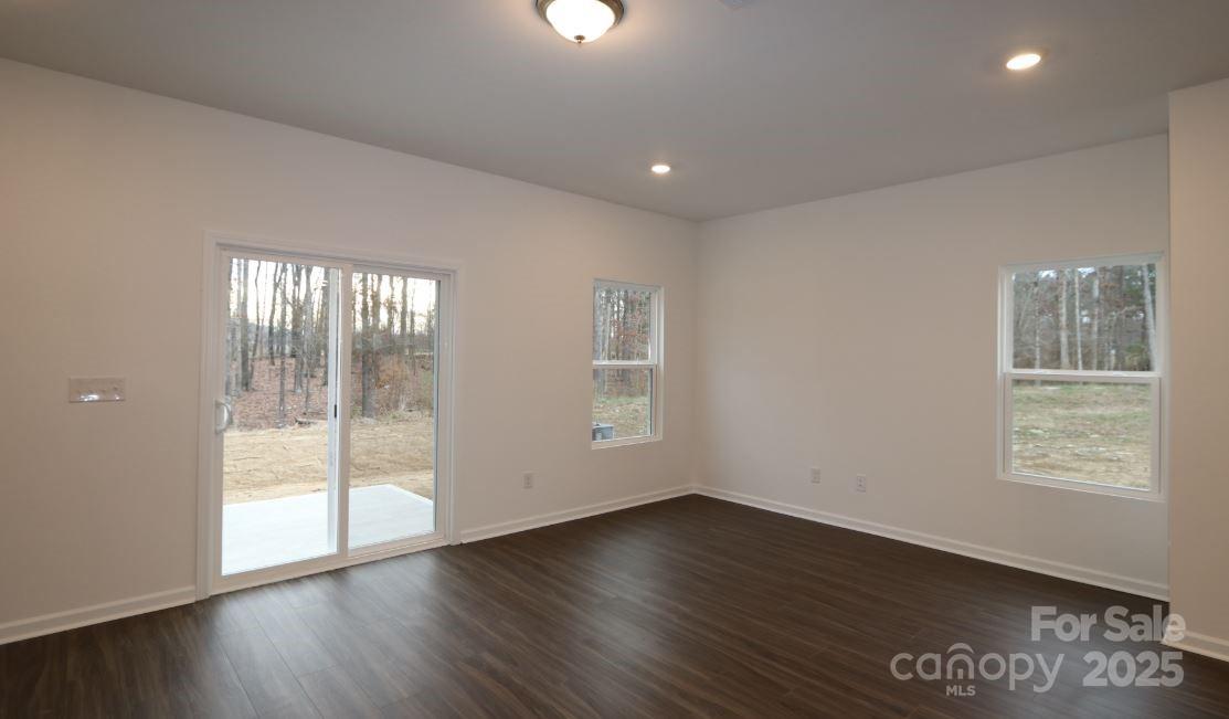 3540 Nimbell Road Monroe, NC 28110 - Photo 3 of 9 an empty room with wooden floor and windows