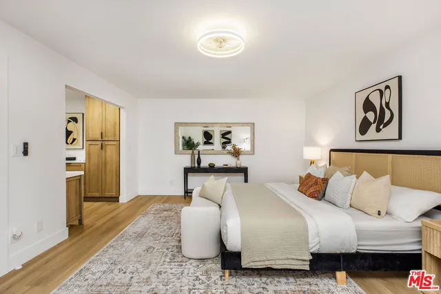 a bedroom with a bed and wooden floor