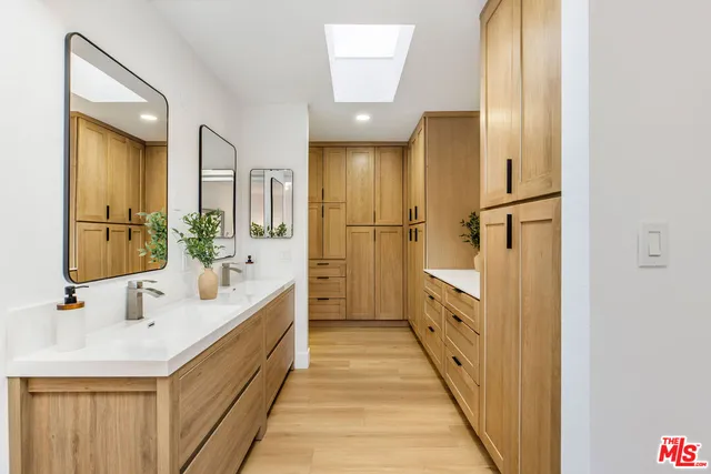 a bathroom with a double vanity sink and mirror