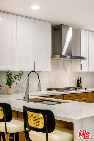 a kitchen with a sink and a stove top oven