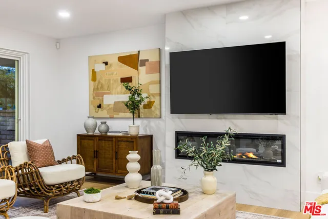 a living room with fireplace furniture and a flat screen tv