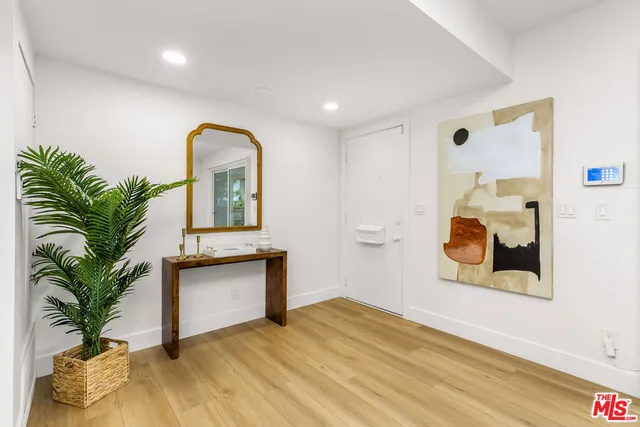 a view of a room with wooden floor and potted plant
