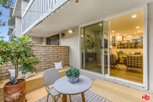 a balcony with table and chairs