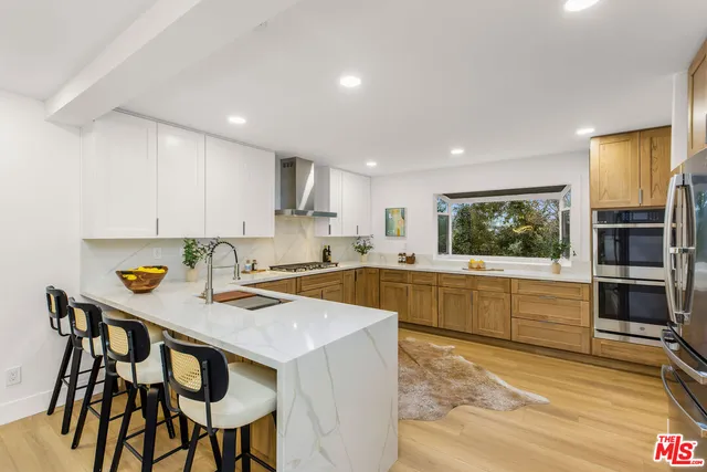 a kitchen with a table chairs microwave and cabinets