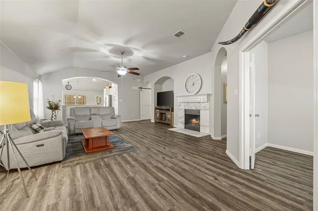 a living room with furniture and a fireplace