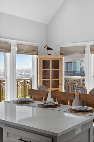 a dining table with chairs and window