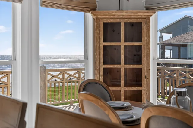 a view of a balcony door with furniture and front door