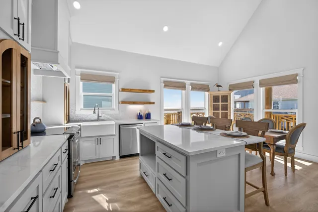 a kitchen with sink stove and cabinets