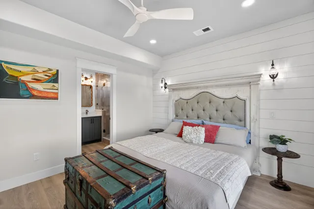 a bedroom with a bed and a painting on the wall