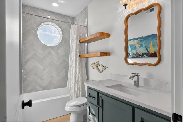 a bathroom with a granite countertop sink toilet and a mirror