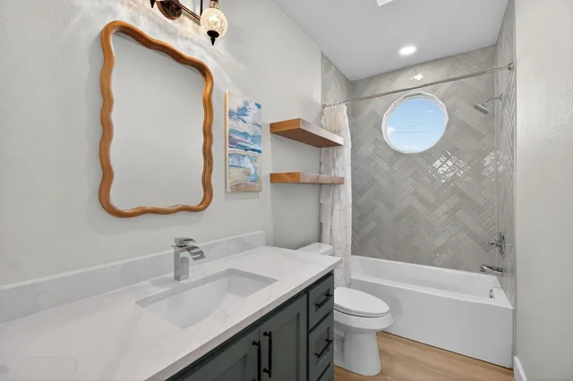 a bathroom with a sink a toilet and tub