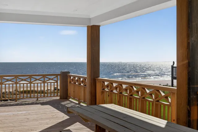 a wooden bench sitting in front of a building
