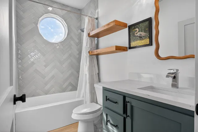 a bathroom with a sink a toilet and a bathtub