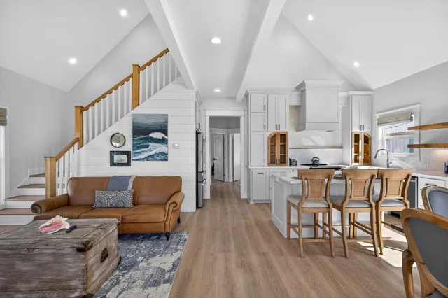 a living room with furniture and kitchen view
