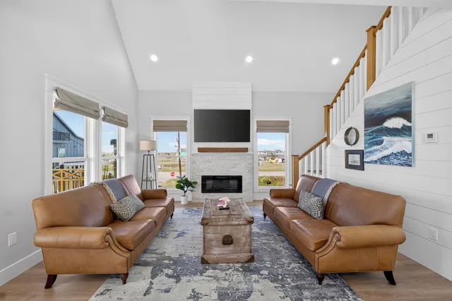 a living room with furniture a fireplace and a flat screen tv