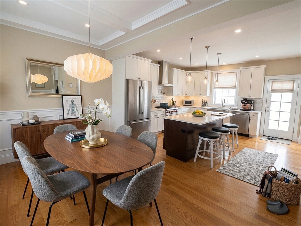 42 Parsons Street Newton, MA 02465 - Photo 11 of 36 a view of a dining room with furniture a chandelier and wooden floor