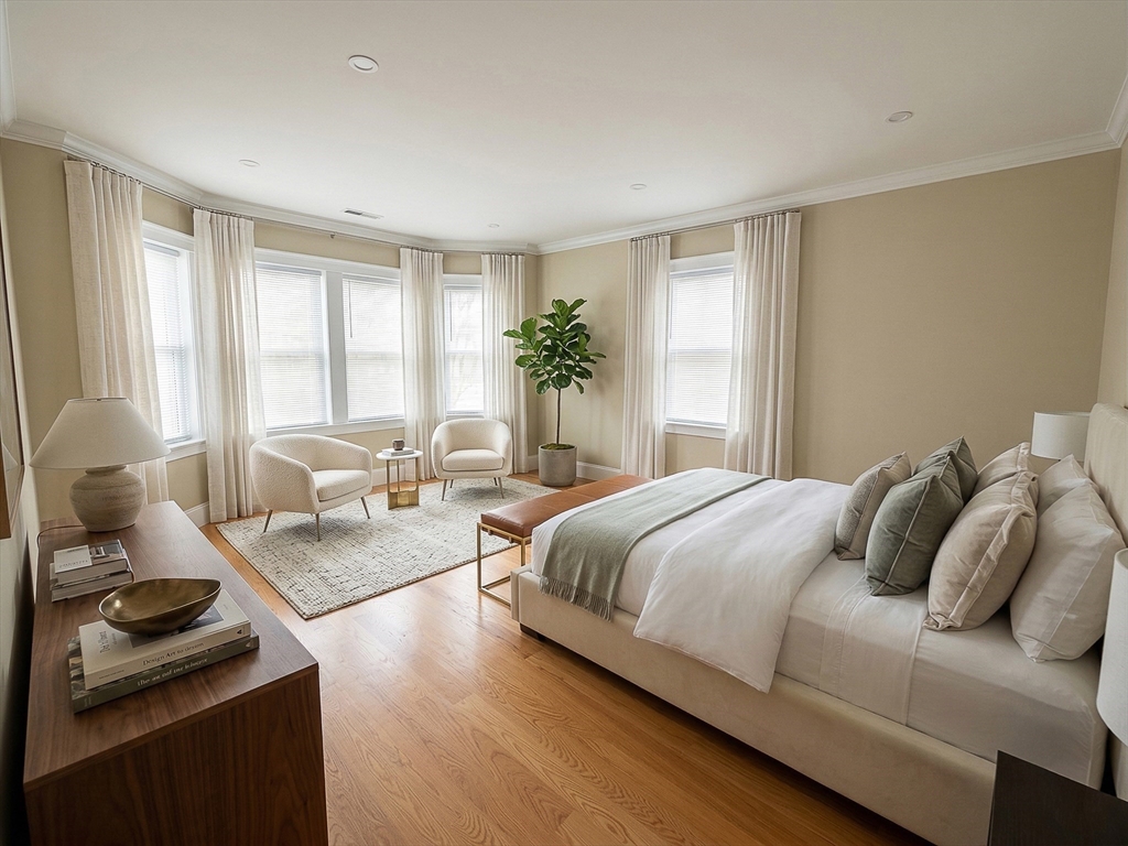 42 Parsons Street Newton, MA 02465 - Photo 18 of 36 a bedroom with a bed and wooden floor