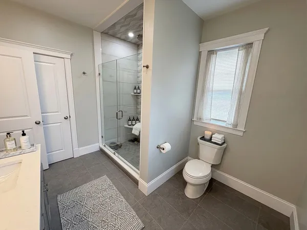 a bathroom with a toilet sink and shower