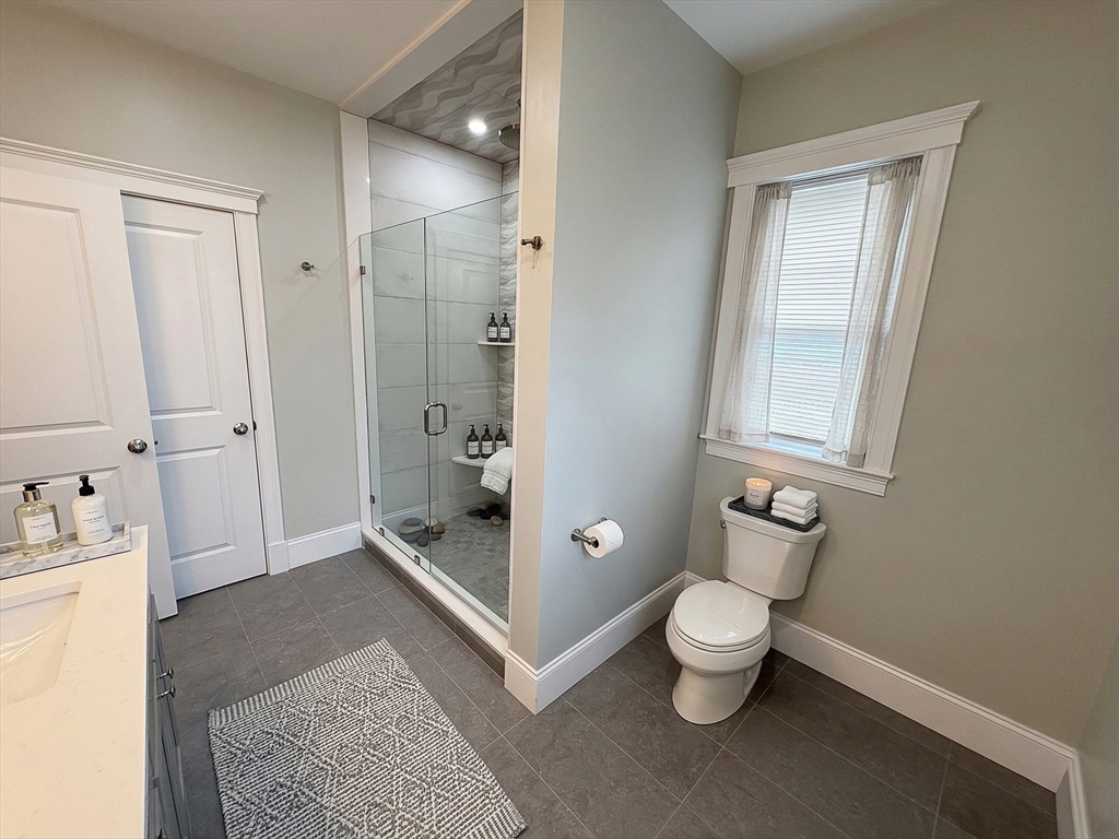 42 Parsons Street Newton, MA 02465 - Photo 22 of 36 a bathroom with a toilet sink and shower