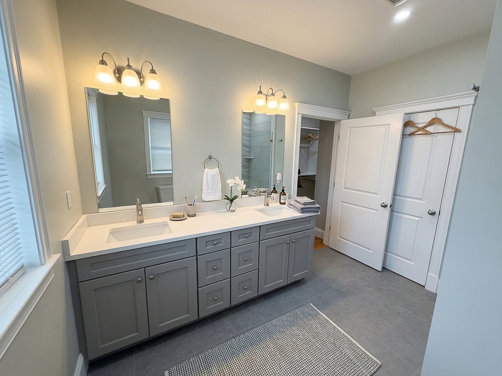 42 Parsons Street Newton, MA 02465 - Photo 23 of 36 a bathroom with a double vanity sink mirror and double