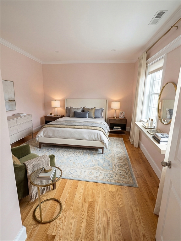 42 Parsons Street Newton, MA 02465 - Photo 25 of 36 a bedroom with a bed and a chandelier