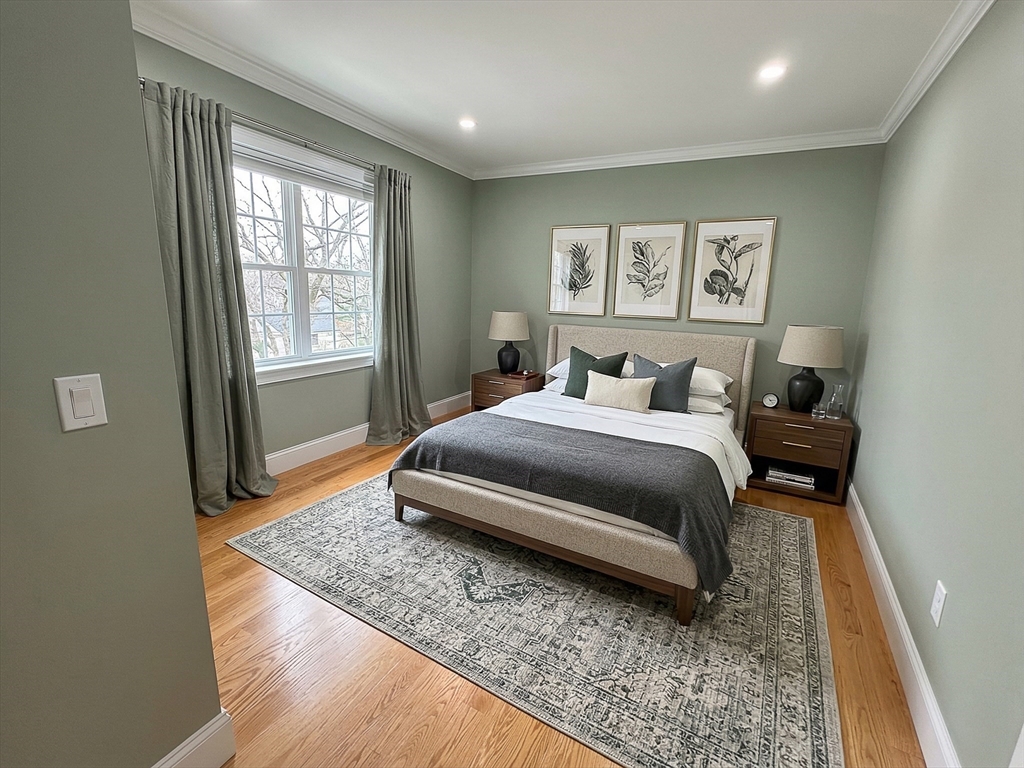 42 Parsons Street Newton, MA 02465 - Photo 26 of 36 a bedroom with a bed and wooden floor