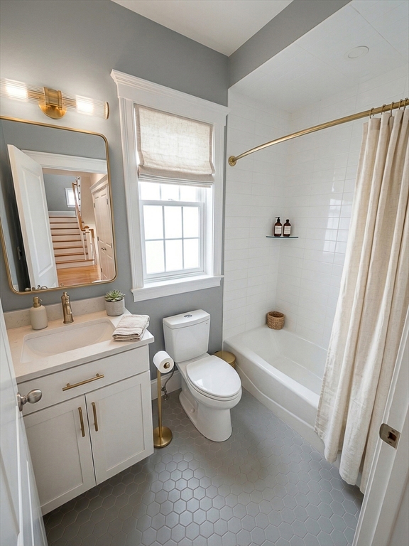 42 Parsons Street Newton, MA 02465 - Photo 29 of 36 a bathroom with a toilet sink and mirror with bathtub