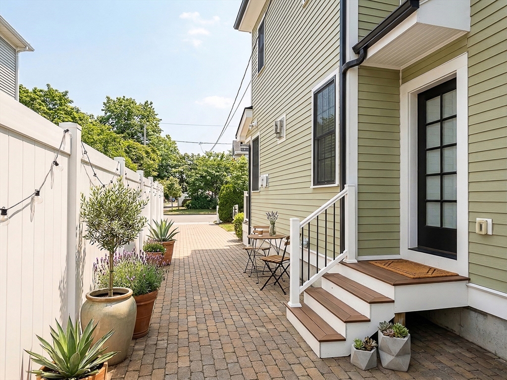42 Parsons Street Newton, MA 02465 - Photo 35 of 36 a view of a patio with a table and chairs and a potted plant