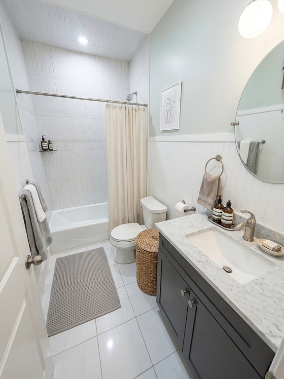 42 Parsons Street Newton, MA 02465 - Photo 6 of 36 a bathroom with a granite countertop sink a toilet and shower