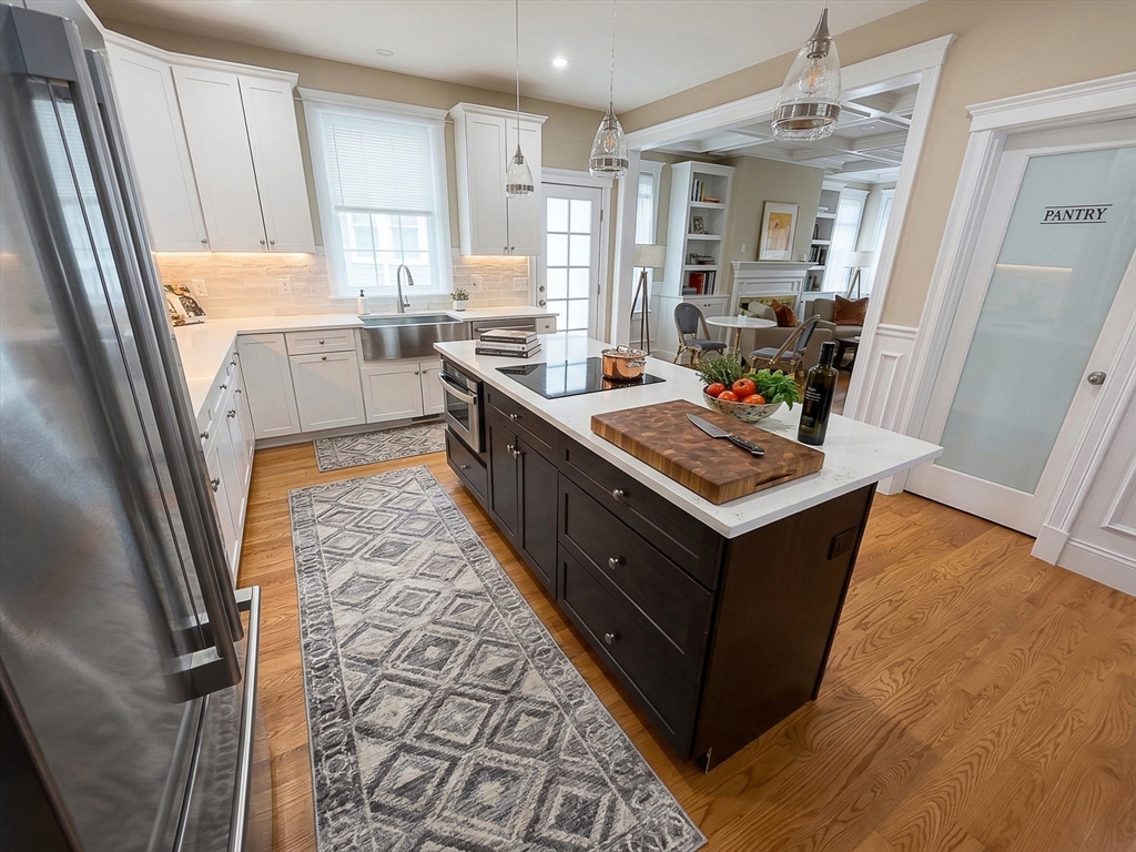 42 Parsons Street Newton, MA 02465 - Photo 9 of 36 a kitchen with granite countertop a sink stove and cabinets