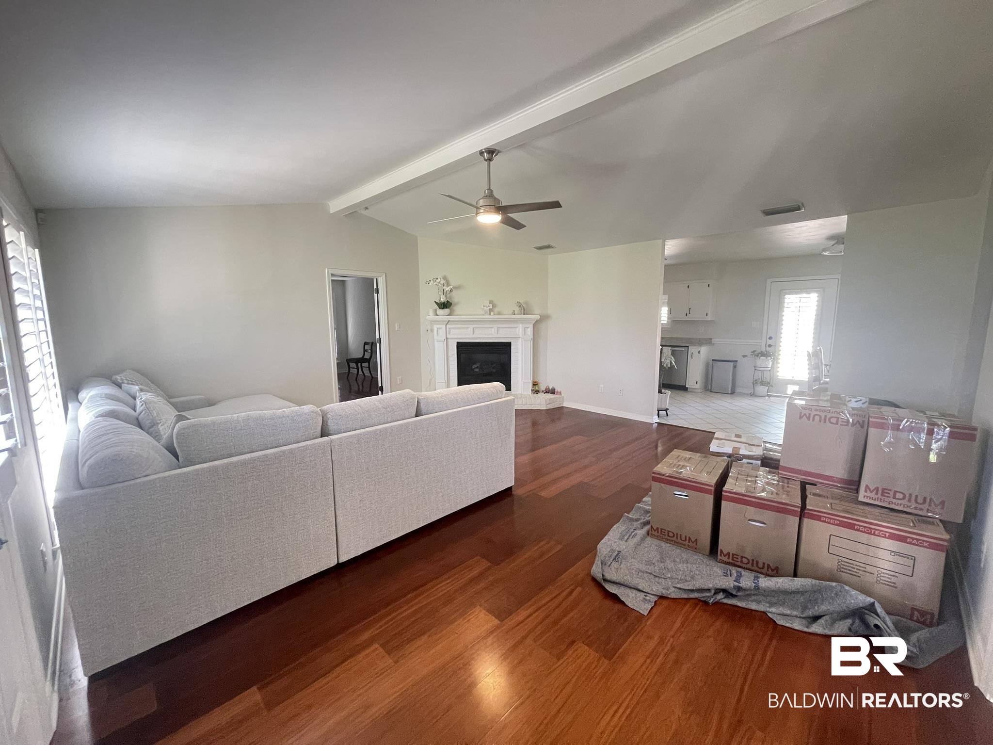 35405 Pine Road South Stapleton, AL 36578 - Photo 7 of 29 Living room featuring dark wood-type flooring, beam ceiling, ceiling fan, and a fireplace