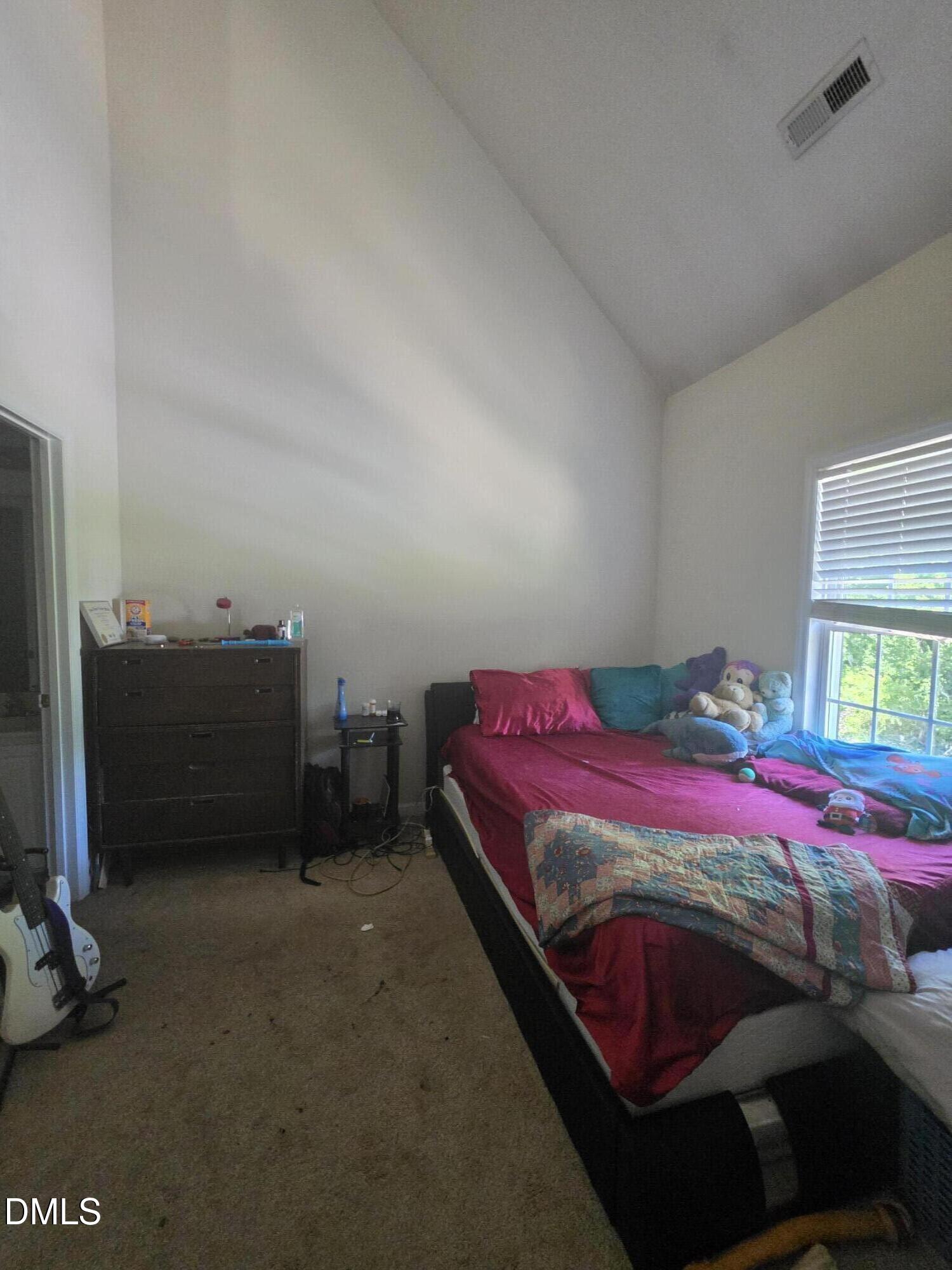 2405 Trout Stream Drive Raleigh, NC 27604 - Photo 7 of 13 a bedroom with a bed and a window