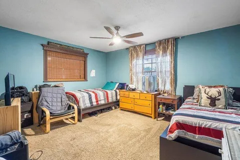 a bathroom with a sink a toilet a mirror and shower curtain