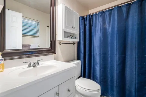 a bedroom with two beds and a chandelier