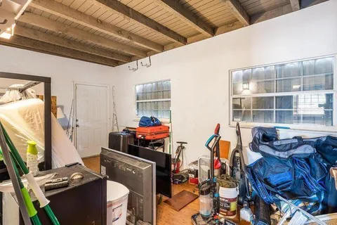 a view of a backyard with wooden fence