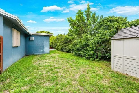 an aerial view of residential houses with outdoor space and street view