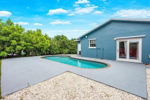 a kitchen with stainless steel appliances granite countertop a sink refrigerator and cabinets