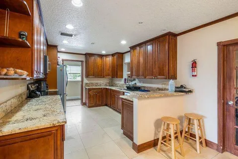 a kitchen with a sink counter top space appliances and cabinets