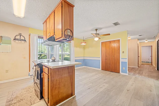 a view of a kitchen with a sink and a refrigerator