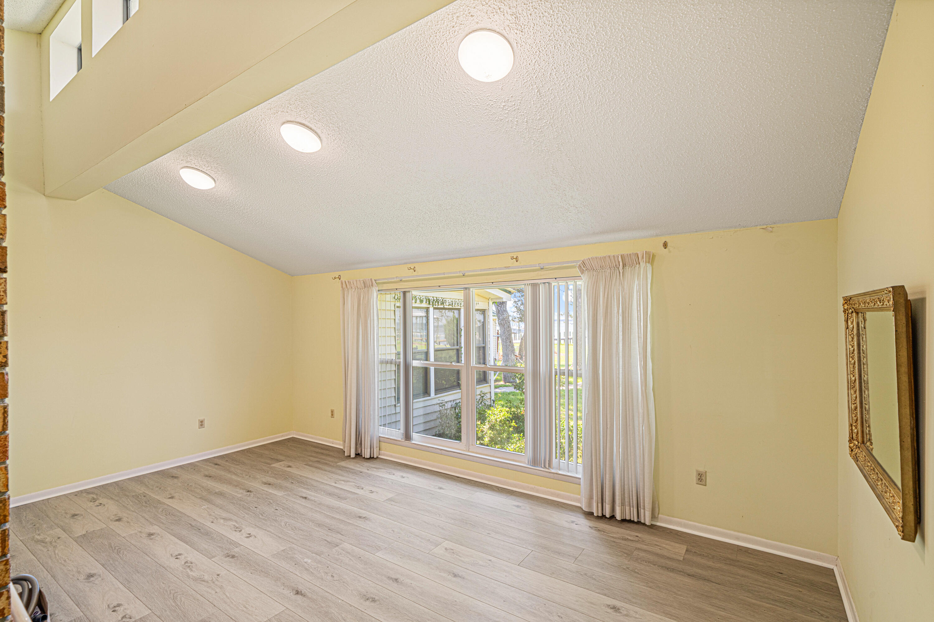 2744 Bay Grove Road Freeport, FL 32439 - Photo 16 of 45 an empty room with wooden floor and windows
