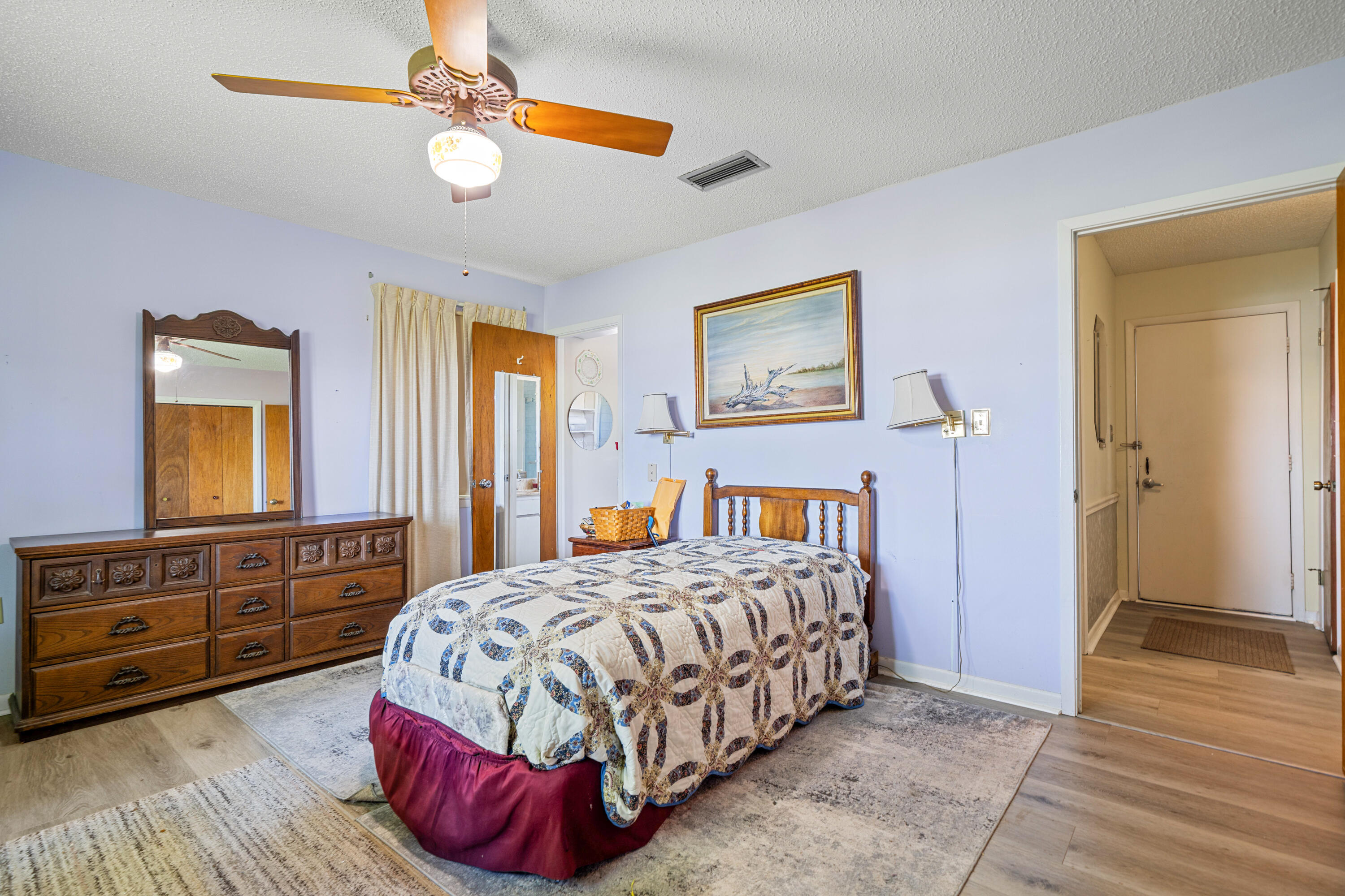 2744 Bay Grove Road Freeport, FL 32439 - Photo 20 of 45 a bedroom with a large bed and a chandelier